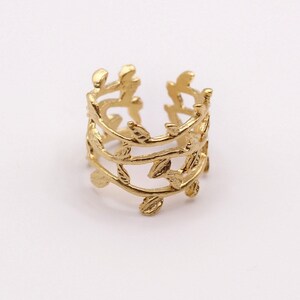 May include: Gold leaf ear cuff with a delicate design of three rows of leaves.
