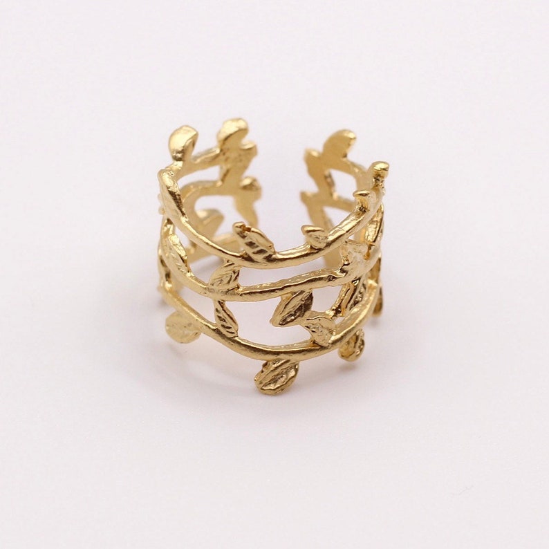 May include: Gold leaf ear cuff with a delicate design of three rows of leaves.