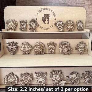 May include: Wooden display shelf with various laser-cut animal figures. The figures are approximately 2.2 inches tall and feature detailed designs of cartoon animals. The shelf has three tiers and includes the text "iWoodwork Shop".