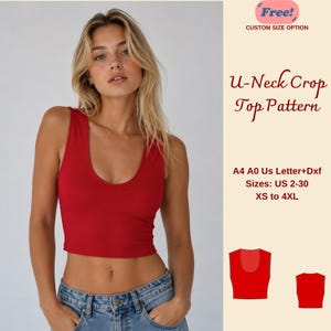 May include: A red U-neck crop top. The image includes the text "U-Neck Crop Top Pattern" and "Sizes: US 2-30 XS to 4XL". The crop top is sleeveless and has a U-shaped neckline. The image also includes a small illustration of the crop top.