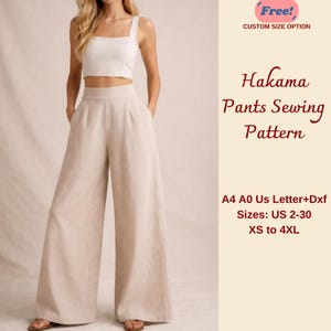 May include: A woman wearing a white crop top and beige Hakama pants. The image includes text that reads "Hakama Pants Sewing Pattern" and "Sizes: US 2-30 XS to 4XL".