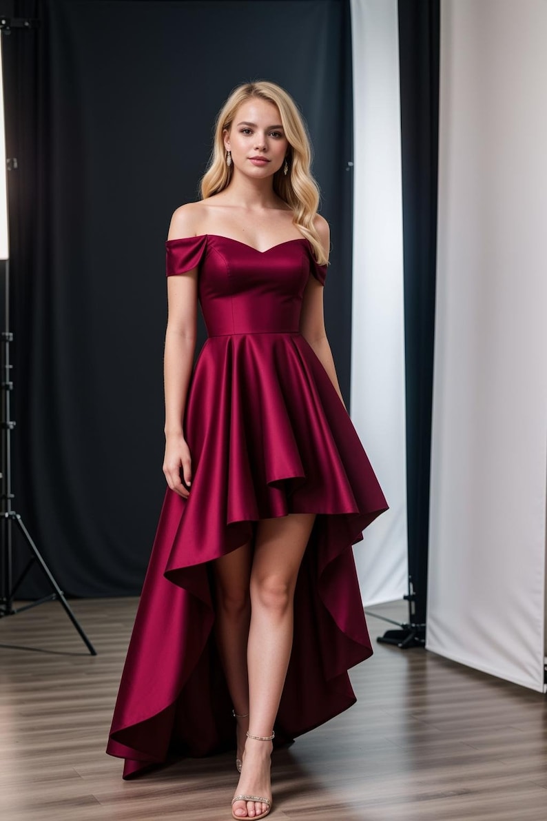 May include: A burgundy off-the-shoulder high-low dress with a sweetheart neckline. The dress has a fitted bodice and a flowing skirt that is shorter in the front and longer in the back.