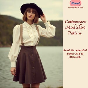 May include: A brown mini skirt with a high waist and button detailing. The skirt is being worn by a model with a white blouse and suspenders. The text on the image reads "Cottagecore Mini Skirt Pattern", "Free! Custom Size Option", "A4 A0 Us Letter+Dxf", "Sizes: US 2-30 XS to 4XL".
