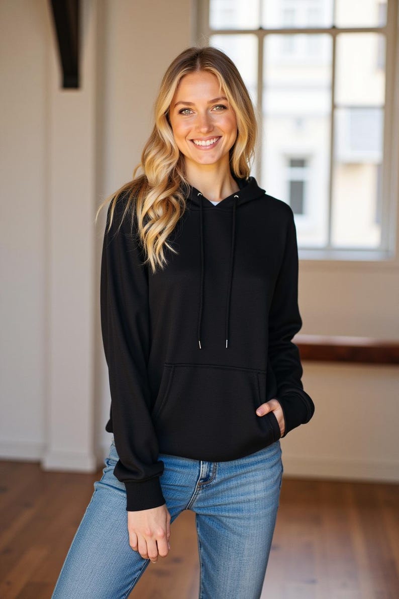 May include: A black hooded sweatshirt with a drawstring hood and a kangaroo pocket. The sweatshirt is made of a soft, comfortable fabric.