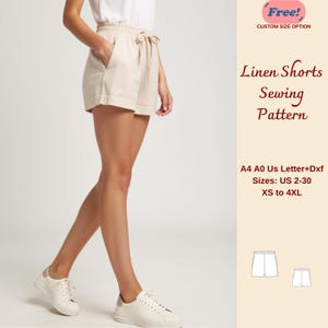 Pode incluir: Calções de linho bege com cintura com cordão e bolsos. A imagem mostra um padrão de costura com o texto "Linen Shorts Sewing Pattern" e tamanhos de XS a 4XL.