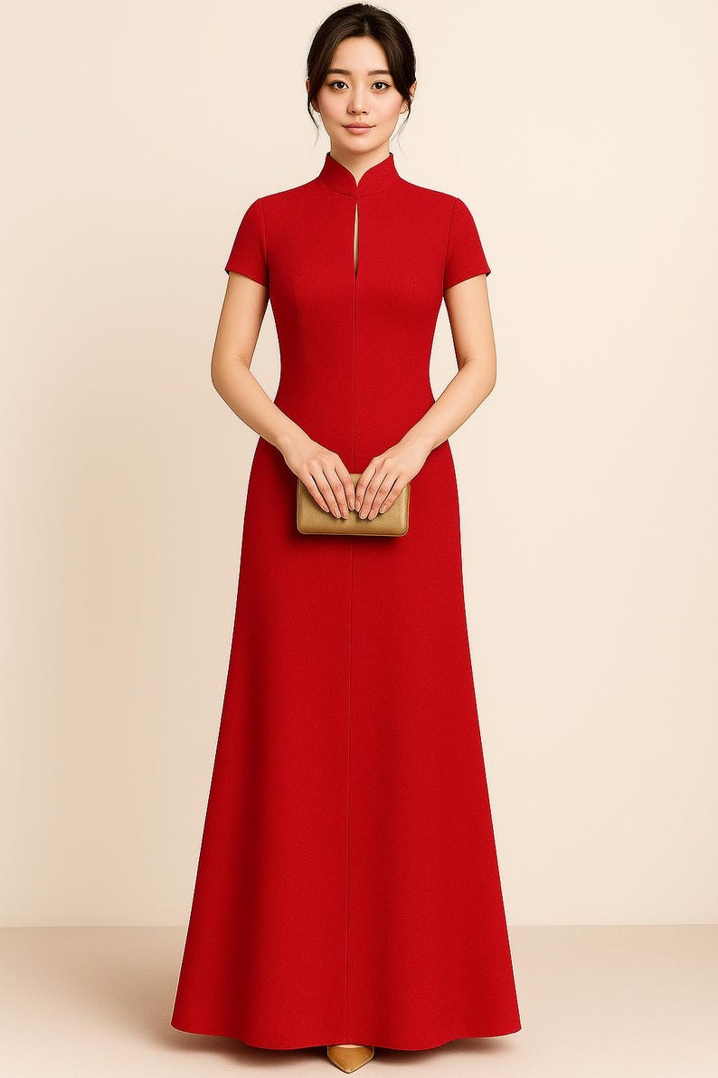 May include: A vibrant red, floor-length dress with short sleeves and a mandarin collar. The dress features a front slit and is paired with a small, gold clutch. The dress is a formal style, suitable for special occasions.