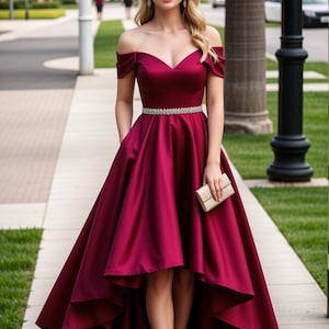 May include: A burgundy off-the-shoulder high-low dress with a beaded belt and short sleeves. The dress has a fitted bodice and a flowing skirt.