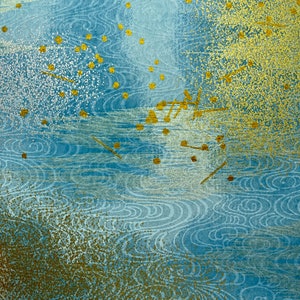 May include: Abstract blue and gold textured background with a swirling pattern. The background has a subtle shimmer and a speckled texture.