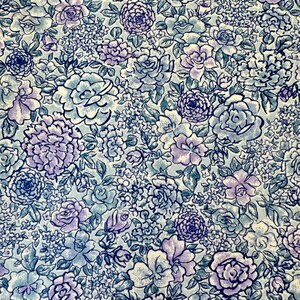 May include: A blue and purple floral print fabric with a white background. The fabric features a variety of flowers, including roses, carnations, and daisies.