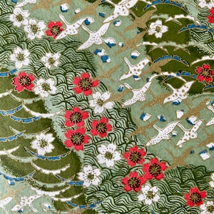 May include: Decorative paper with a Japanese-inspired design. The pattern features white birds in flight, red and white flowers, and gold accents on a green and light green background. The design includes stylized waves and blue accents.