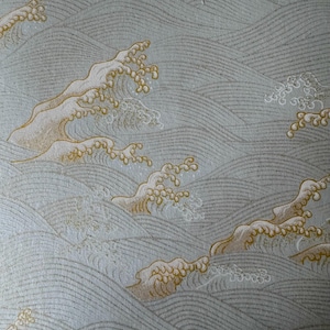 May include: A repeating pattern of stylized ocean waves in shades of gray and beige. The design features curved lines representing the waves, with detailed crests and foam in a lighter color. The overall aesthetic is reminiscent of traditional Japanese art.