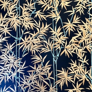 May include: A dark navy blue fabric featuring a repeating pattern of bamboo stalks. The bamboo stems are outlined in light blue, while the leaves are rendered in a metallic gold finish, creating a high-contrast design across the entire surface.