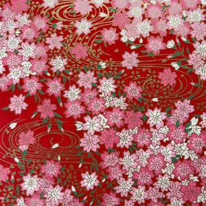May include: Red background with a repeating pattern of pink and white cherry blossoms and gold swirls.