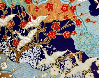 May include: A blue background with white cranes flying among red and white flowers. The background is decorated with gold and silver accents.