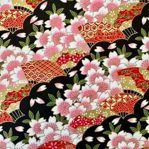 May include: A black and red patterned fabric with a repeating design of cherry blossoms, fans, and geometric shapes. The fabric has a gold metallic sheen.