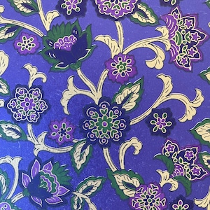 May include: Purple and gold floral patterned paper with a repeating design of flowers and leaves.