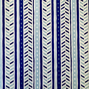 May include: A white fabric with a repeating pattern of blue and light blue stripes. The stripes are made up of a chevron pattern and a dotted pattern.