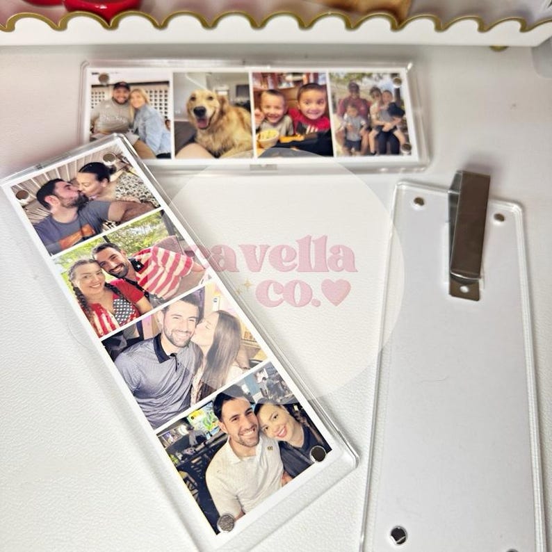 May include: Clear acrylic photo bookmarks with multiple family photos. One bookmark has a series of photos, and the other has a single row of photos. The text "avella co.&hearts;" is visible on the surface.