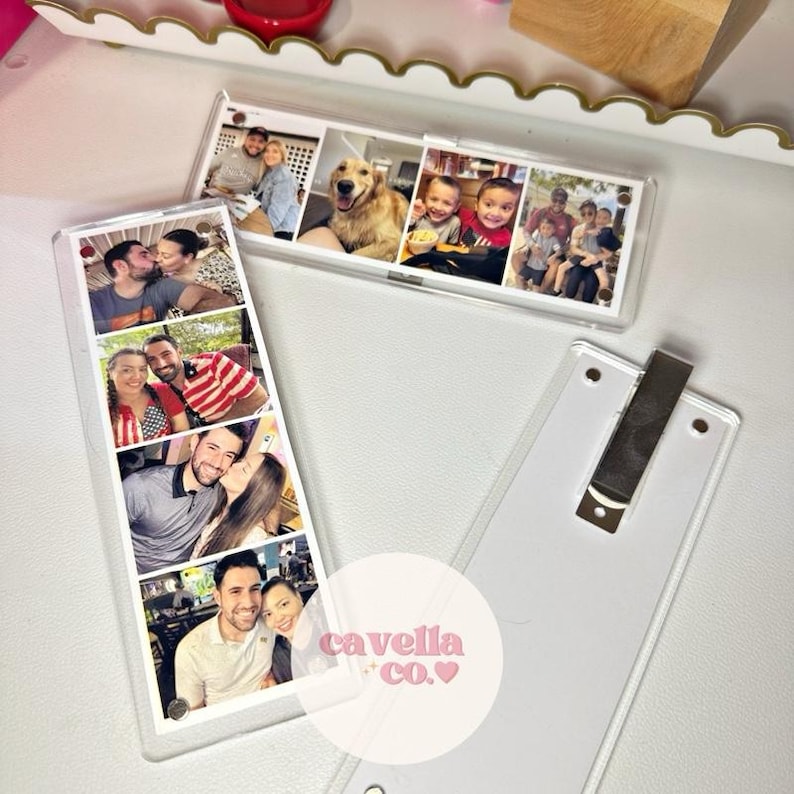 May include: Clear acrylic photo holders with multiple family photos. One holder is upright, and the other is horizontal. The photos show couples, children, and a dog. The brand name "cavella co." is visible.