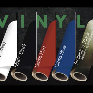 May include: Five rolls of vinyl in matte white, matte black, gloss red, gloss blue, and reflective black. The word VINYL is displayed in green at the top. Each roll is labeled with its color and finish, with reflective black noted as available.
