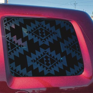 May include: A dark maroon vehicle features a rear side window adorned with a black adhesive decal. The decal displays a repeating geometric pattern consisting of sharp, jagged triangles and diamond shapes arranged in a symmetrical, interlocking design.