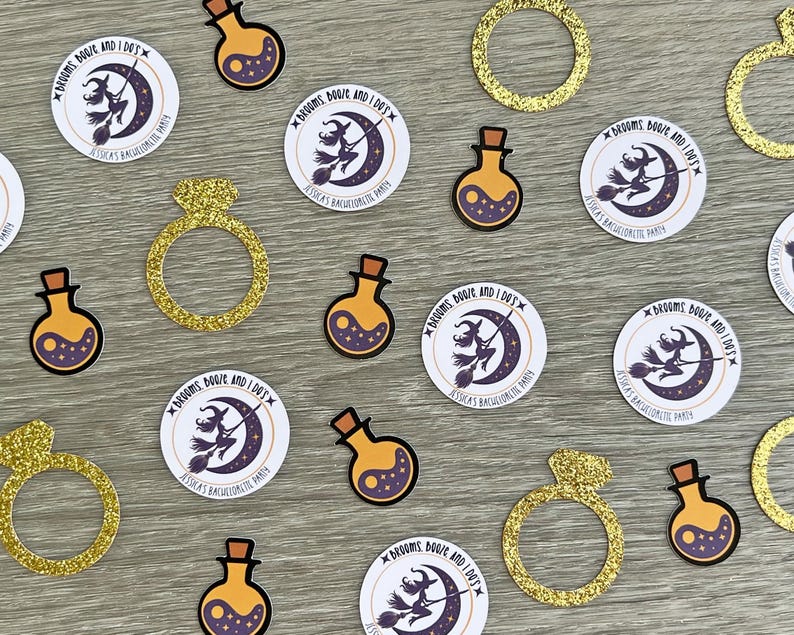 May include: A collection of party decorations, including gold glitter rings, potion bottles, and circular stickers. The stickers feature a witch on a broomstick in front of a crescent moon, with the text "Brooms, Booze, and I Do's" and "Jessica's Bachelorette Party."