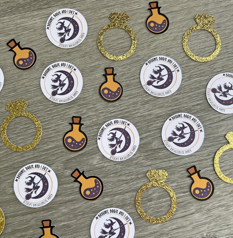 May include: An assortment of party decorations, including gold glitter ring cutouts, potion-shaped stickers, and round stickers with a witch on a broom and the text "Brooms, Booze, and I Do's".