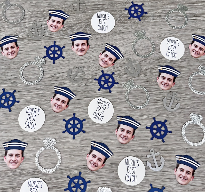 May include: A collection of confetti featuring a nautical theme. The confetti includes anchors, steering wheels, rings, and images of people wearing sailor hats. The confetti is printed with the text "Laurie's Best Catch".