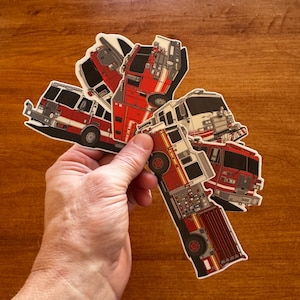 May include: A white ceramic mug with a black handle and the text "But First, Coffee" in a bold, black font. The mug is set against a neutral background, highlighting its simple design.