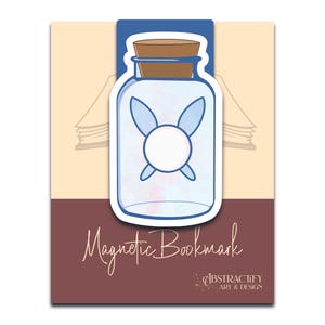 May include: A magnetic bookmark featuring a cartoon fairy in a glass bottle design. The bookmark has a blue border, a brown cork, and the words "Magnetic Bookmark" in a cursive font. The background is tan and maroon.