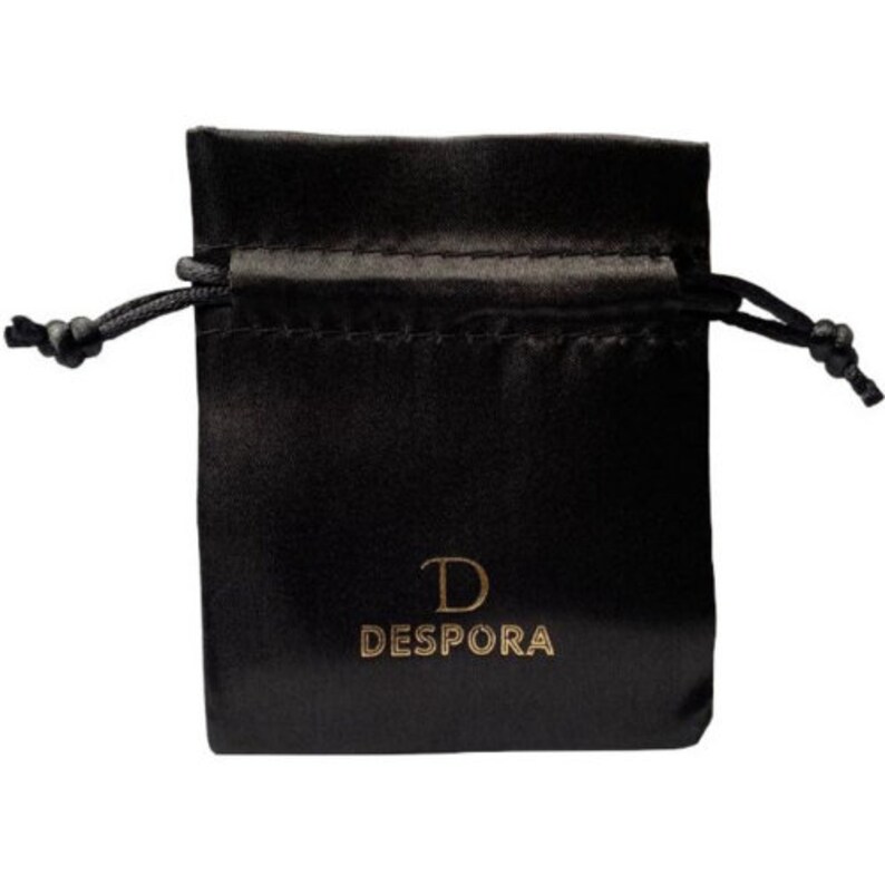 May include: Black satin drawstring bag with a gold logo that reads "D DESPORA".