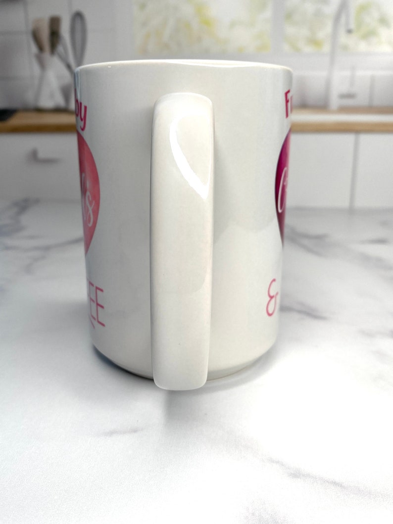 May include: White ceramic mug with a pink heart and the text "For Coffee & Cuddles" on it.