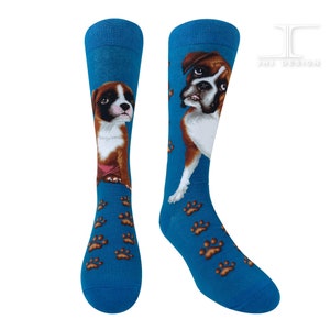 May include: A pair of blue socks with a brown and white boxer dog design. The socks feature paw prints on a blue background.