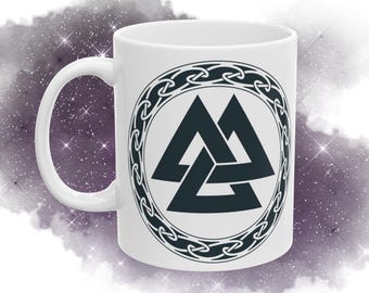 May include: White ceramic mug with a black and white design of a triple triangle symbol inside a circular chain pattern.