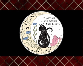 May include: A black cat silhouette with a constellation design sits inside a crescent moon, surrounded by stars, flowers, and crystals. The text "NOT ALL WHO WANDER ARE LOST" is above the cat. The design is set against a black background.