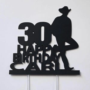 May include: Black cake topper with a silhouette of a cowboy and the text "30 Happy Birthday Carl".