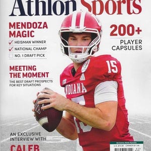 May include: The cover of Athlon Sports magazine features a football player in a red uniform and helmet, holding a football. Text includes "2026 NFL Draft Preview," "Mendoza Magic," and "Caleb Downs." The magazine cover also has the text "200+ Player Capsules."