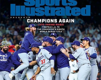May include: Sports Illustrated magazine cover featuring a group of baseball players celebrating a victory. The cover reads "Dodgers! Champions Again" and "Late-inning magic propels L.A. to the franchise's eighth World Series title."