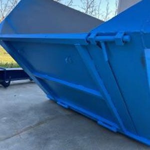 May include: A blue metal skip with a hinged back door. The skip is tilted up, revealing the inside.