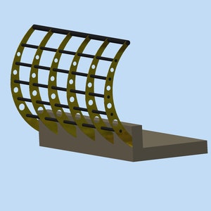 May include: A gold metal bucket attachment for a tractor or other heavy equipment. The bucket has a curved, cage-like design with multiple bars and holes.