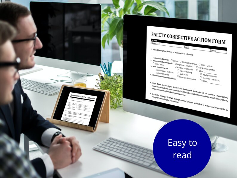 May include: Two people are looking at a computer screen displaying a safety corrective action form. The form has sections for hazard description, seriousness of hazard, what was the hazard, root cause of hazard, immediate action taken, steps taken to investigate hazard, and corrective action. The form is titled "Safety Corrective Action Form".