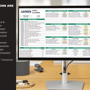 May include: A computer monitor displaying a daily planner titled "ADMIN DAILY PLANNER." The planner includes sections for schedule, priorities, communications, office management, and more. The monitor sits on a wooden desk with office supplies.