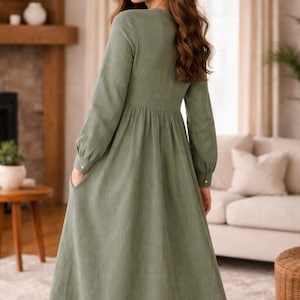 Loose fit gathered midi dress sewing pattern PDF photographed on model, showcasing the button-front design, long sleeves with cuffs, and flowing skirt. Designed for breathable woven fabrics, this women’s sewing pattern creates an easy, flattering everyday dress suitable for casual wear, work from home, and market outings.