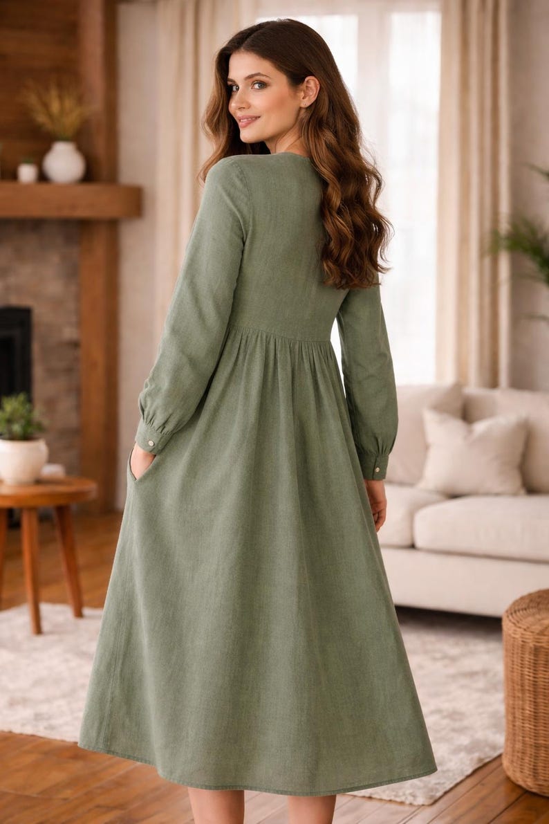 Loose fit gathered midi dress sewing pattern PDF photographed on model, showcasing the button-front design, long sleeves with cuffs, and flowing skirt. Designed for breathable woven fabrics, this women’s sewing pattern creates an easy, flattering everyday dress suitable for casual wear, work from home, and market outings.