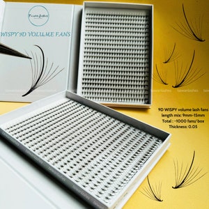 May include: Two white boxes filled with black wispy 9D volume lash fans. The boxes are on a yellow surface. The text on the box reads "WISPY 9D VOLUME FANS" and "9D WISPY volume lash fans length mix: 9mm-15mm Total: -1000 fans/box Thickness: 0.05".