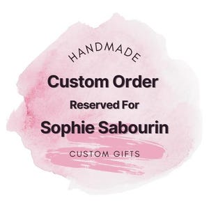 May include: A custom order graphic with the text "HANDMADE Custom Order Reserved For Sophie Sabourin CUSTOM GIFTS" on a pink watercolor background. The text is in a dark color, and the overall design is simple and elegant.