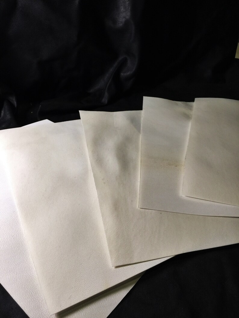 May include: Four white sheets of paper stacked on top of each other. The paper is slightly textured and has a subtle off-white color.