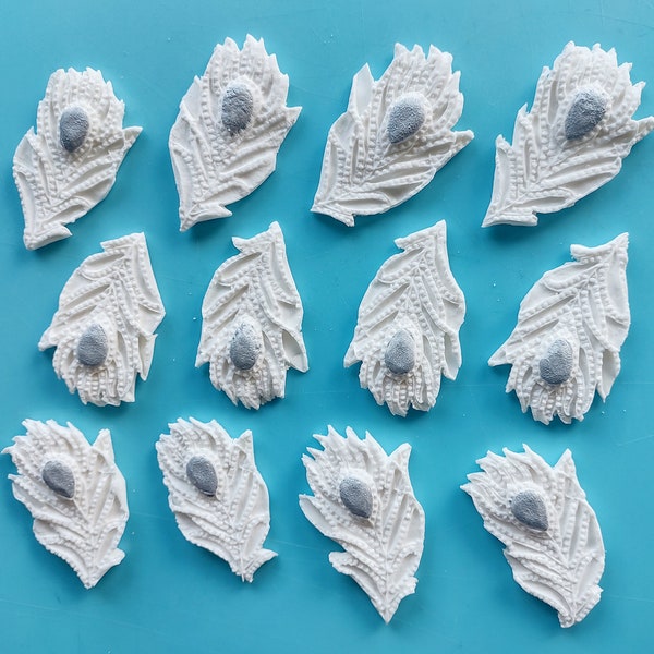 White Peacock Feathers cake/cupcake toppers. A set of 12 edible fondant Peacock Feathers for a cake or cupcakes.