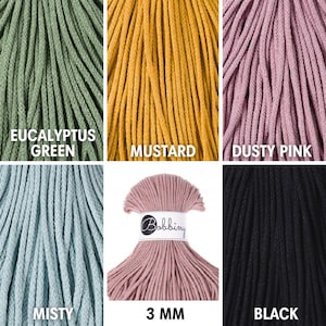 Op de afbeelding: Een assortiment van 3 mm katoenen koord in vijf kleuren: Eucalyptusgroen, mosterd, stoffig roze, mistig en zwart. Het koord is gemaakt door Bobbiny.