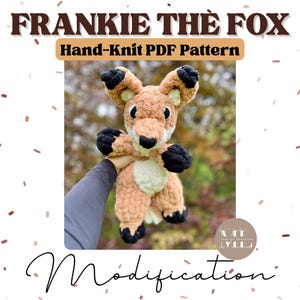 May include: A hand-knitted fox plushie with brown, black, and cream colors. The fox has large ears, a black nose, and black paws. The text "FRANKIE THE FOX" and "Hand-Knit PDF Pattern" are displayed at the top of the image. The word "Modification" is at the bottom.